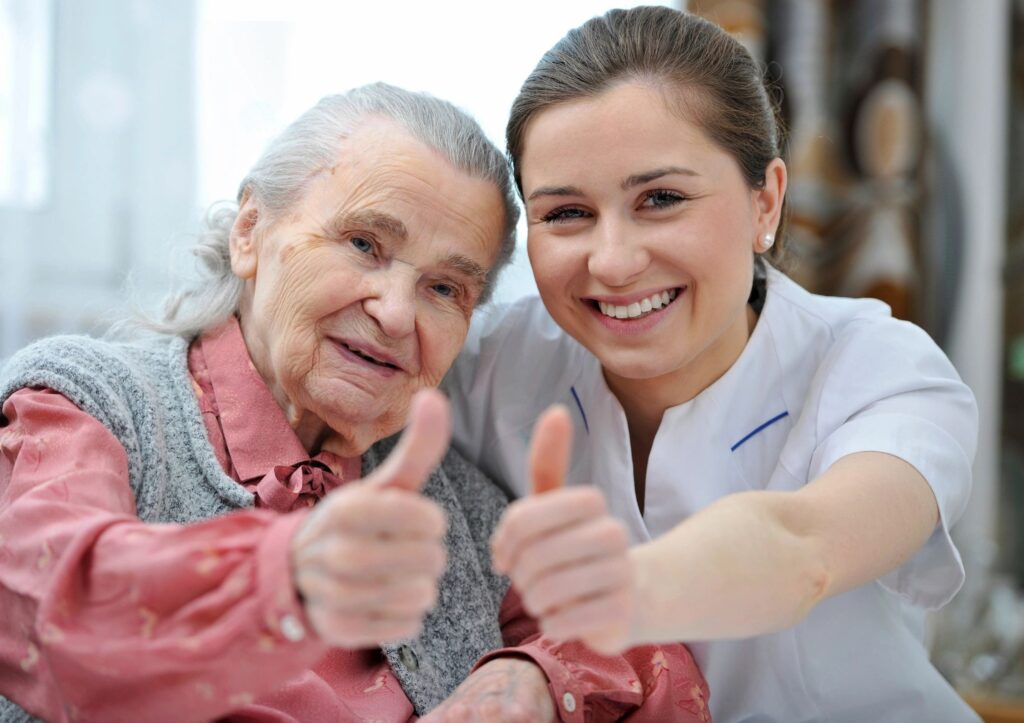 senior and nurse giving thumbs up