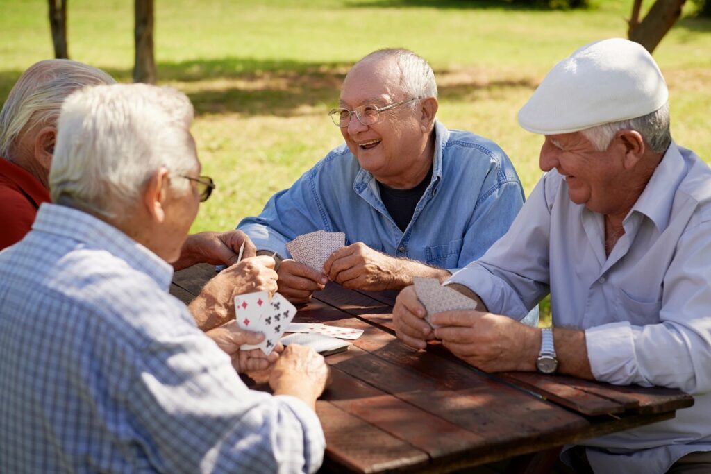 group of senior citizens playing cards