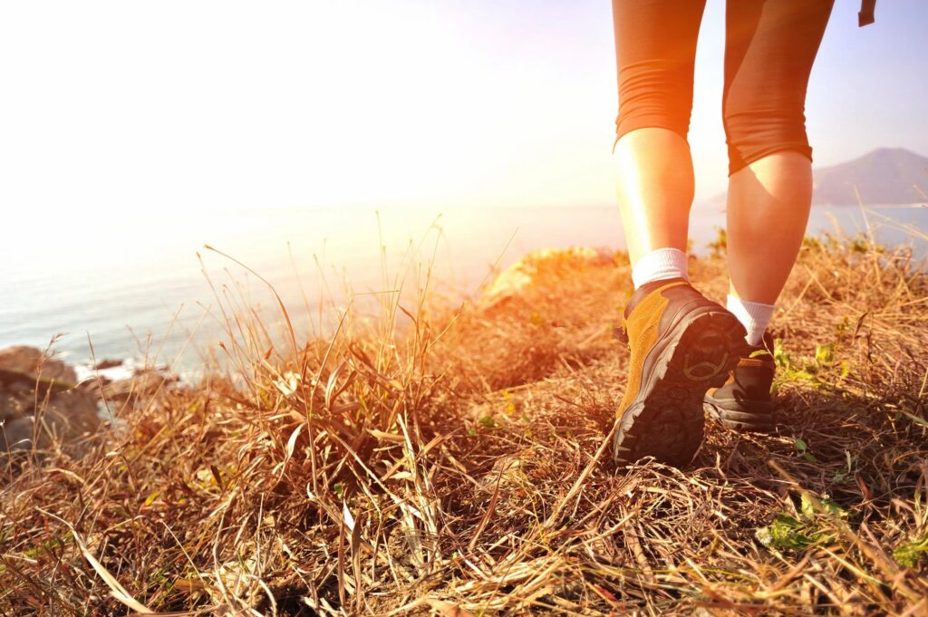 person hiking into the sunset